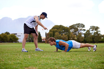Men, push up and personal trainer on grass for workout with clipboard for test, progress or...