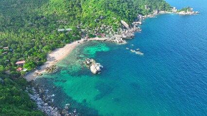 A haven for adventure seekers with crystal-clear waters, lush jungles, and a laid-back island vibe. Aerial view from drone. High-quality video. Gulf of Thailand. Beach background. 4K UHD.
