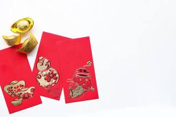 Red envelope and gold sycee on white background. Chinese language mean happiness and happy Chinese new year. 