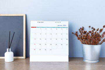 January 2024 calendar schedule , January 2024 calendar on wooden table. Happy new year 2024 concept