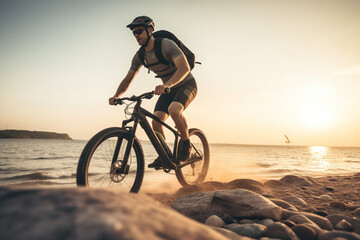 Fototapeta premium cyclist on the beach at sunset