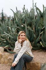 Young woman portrait near the cactus