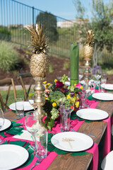 Tropical Theme Table Setting with Gold Pineapples and Flowers