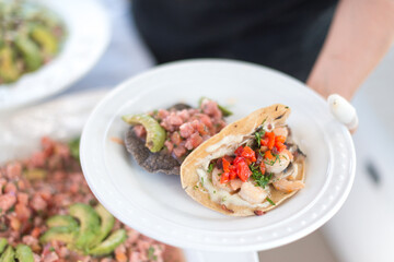 Fish Tacos on a White Plate being Served