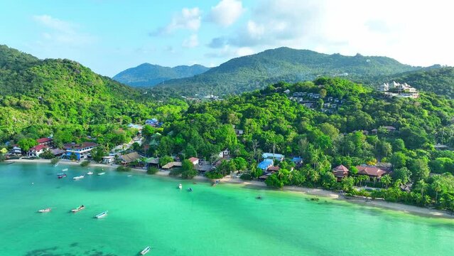 Pristine beaches, thrilling dives, and island adventures await in this Thailand paradise. Bird's eye view. Koh Tao, Southern Thailand. Cinematic footage. Tropical sea background. 4K HDR.
