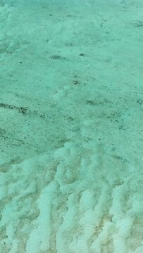 Top view of sandy ocean floor on sea surface in Surigao del Sur, Philippines. Vertical view.