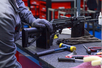 Assembling firearms by a factory worker in the workshop.