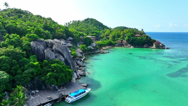 Serene haven adorned with lush greenery, pristine beaches, and azure waters-a retreat for mindful souls seeking inner harmony. Drone aerial view. High-quality video. Koh Tao, Thailand. 4K HDR.
