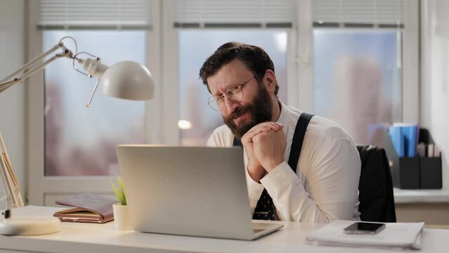 Panic, fear, error concept. Frightened man in office is afraid and worried about something. Office worker praying for good result and expressing his concern, fuss, anxiety