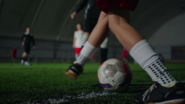 Teens Girls Playing Soccer Indoors, Closeup View Of Ball And Feet On Artificial Grass Of Players