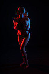 Fototapeta premium Low key portrait of beautiful female body on dark background