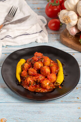 Aleppo meatballs. Appetizer dishes. Small meatballs with tomato paste on a blue wooden background