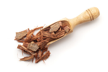 Top view of a wooden scoop filled with Organic Arjuna Barks (Terminalia Arjuna). Isolated on a white background.