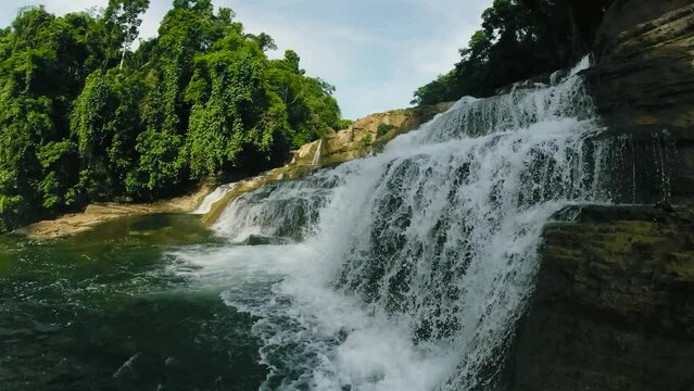 Water cascading over the rock level structures. Tinuy-an Falls. Bislig, Surigao del Sur. Philippines.