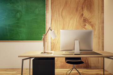Detailed view of a modern classroom's teacher desk with green chalkboard, wooden elements, evening...