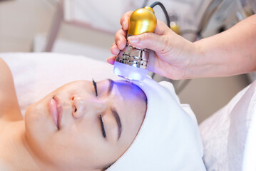 Facial treatment with laser and ultrasound in a medical spa center skin rejuvenation concept