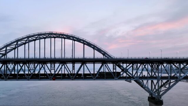 aerial video of the freight trains passing through the Jiujiang Yangtze River Bridge in early morning, China