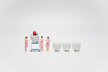 Figure cavity and decay teeth with sweet candy were forced by nurse to checking dental examination and treatment with healthy tooth on white background