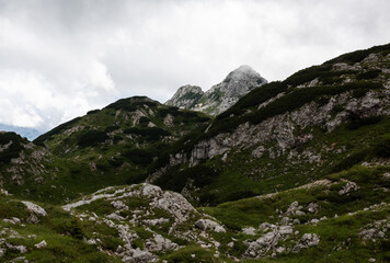 Rolling green hills and granite rock in the Julian Alps