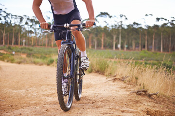 Person, bike and countryside for nature, off road and cycling for health and wellness. Athlete, bicycle and training for workout, transportation and exercise with cape town mountain trail for fitness
