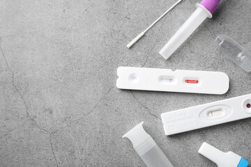 Disposable express test kits on grey table, flat lay. Space for text