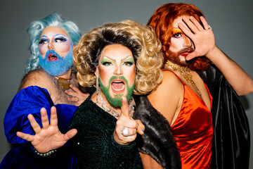 Group of drag queens pointing a finger at camera in defiance