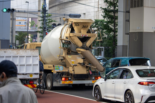 Tokyo, Japan, 4 November 2023: Urban Traffic Scene with Cement Mixer and Cars.