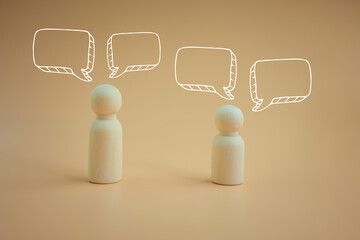 Wood peg doll with pop up of empty speech bubbles. A speech bubble indicating conversation in life