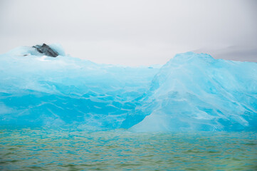  closeup texture of bright blue iceberg. Enviromental issues, global warming concept