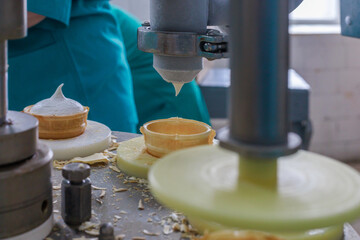 Production of tasty ice cream in the waffle cup.