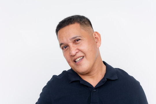 Middle-aged Asian man with a leery expression, looking sideways. Isolated on a clean white background.