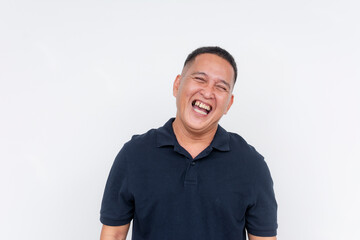 Portrait of a cheerful middle-aged Asian man laughing heartily, with a white background providing copy space.