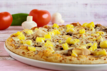 Hawaiian Pizza closeup topping with capsicum, mushroom, tomato and olives served in dish isolated on table side view of arabic fastfood
