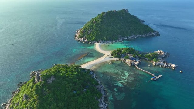 Breathtaking beaches, lush greenery, and a magical sandbar intertwine, creating a sublime paradise across three stunning islands. Top view Aerial view of drone. Sea stock footage. Koh Tao, Thailand.
