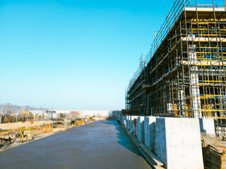 construction site with scaffolding and building materials, blue sky background