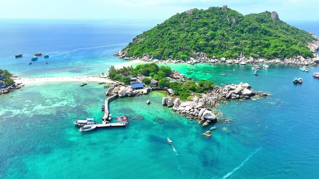 Explore a secluded island boasting a unique powdery sandbar, inviting you to snorkel amidst colorful marine creatures and relax under the sun. Ko Nangyuan, Surat Thani Province, Southern Thailand.
