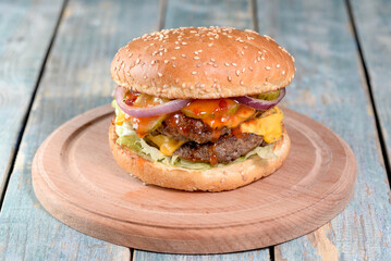 burger on a wooden board