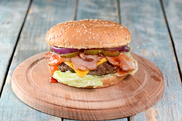 burger on a wooden board