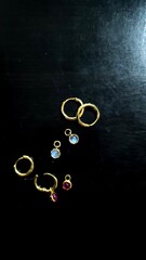 earring 18k Gold setting with gems stone on black background. Jewelry set for strore