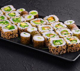 vegetarian sushi rolls on black plate