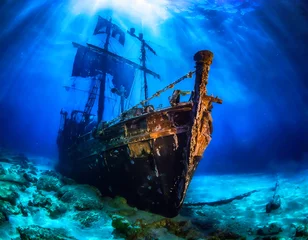Deurstickers Ancient sunken pirate ship resting in the depths of the blue sea. Underwater photo © Arda ALTAY