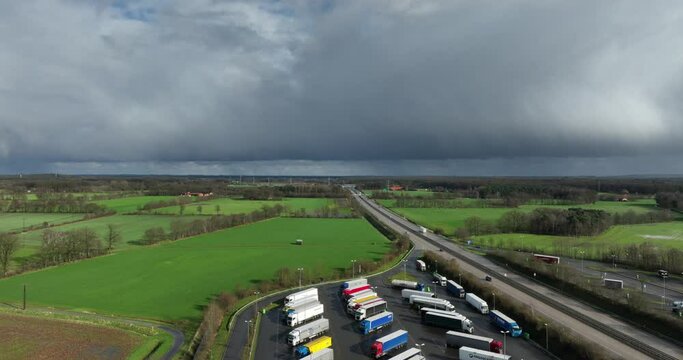 aerial footage of rainclouds moving away over the German E30 highway. Below you see Waldseite-Nord parking place.