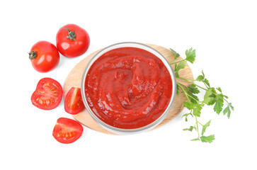 Organic ketchup in bowl, fresh tomatoes and parsley isolated on white, top view. Tomato sauce