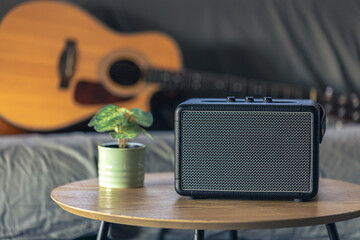 Close up, music speaker and acoustic guitar in the interior of the room.