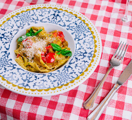 Italian pasta with tomatoes, parmesan and basil