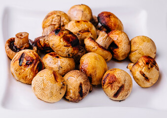 Baked mushrooms in plate close up
