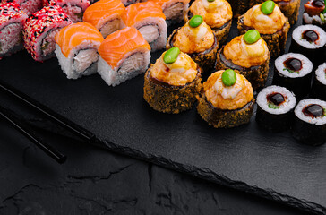Sushi set on black slate top view