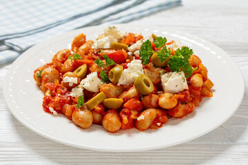 greek giant baked beans with feta, olives on plate