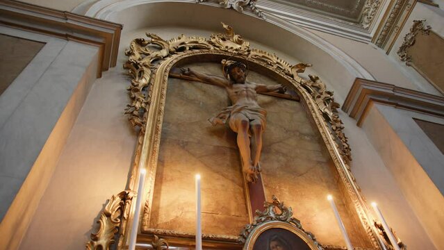 Candles under Christ crucifix in a Church