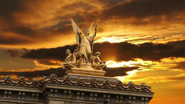 Golden statue of Liberty on the roof of the Opera Garnier (Garnier Palace)  against the background of the sunset. Sculpted by Charles Gumery in 1869. Paris, France. 4K, time lapse, with zoom 